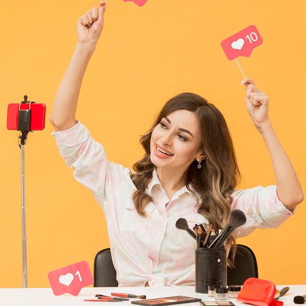 OnlyFans creator filming at her desk and celebrating incoming likes from engaged subscribers